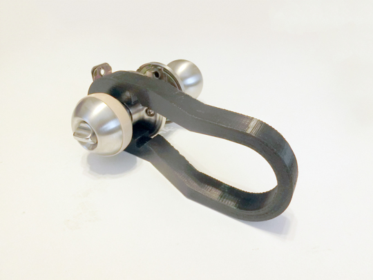 Partially-installed kit; a doorknob with lever component and rubber band.